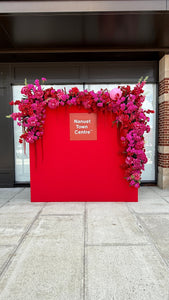 Red backdrop with floral decorations 